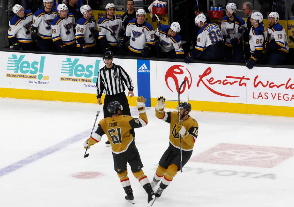 Golden Knights right wing Mark Stone (61) celebrates with Golden Knights center Nicolas Roy (10 ...