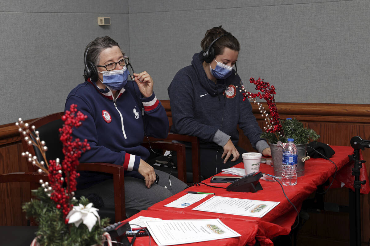 In this photo released by the U.S. Department of Defense, volunteers answer phones and emails f ...