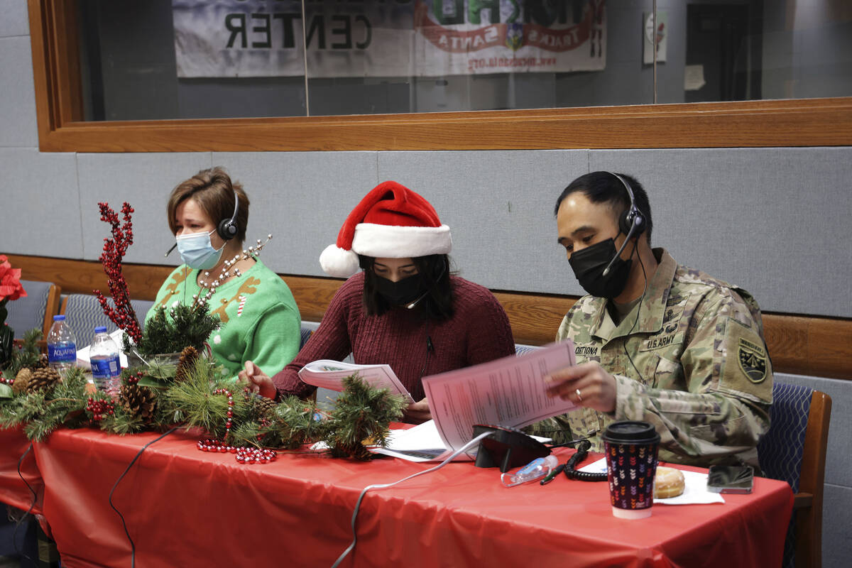 In this photo released by the U.S. Department of Defense, volunteers answer phones and emails f ...