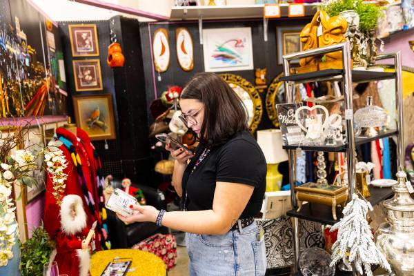 Rebecca Robledo, social media manager at Charleston Antique Mall, records a clip of a Monopoly- ...