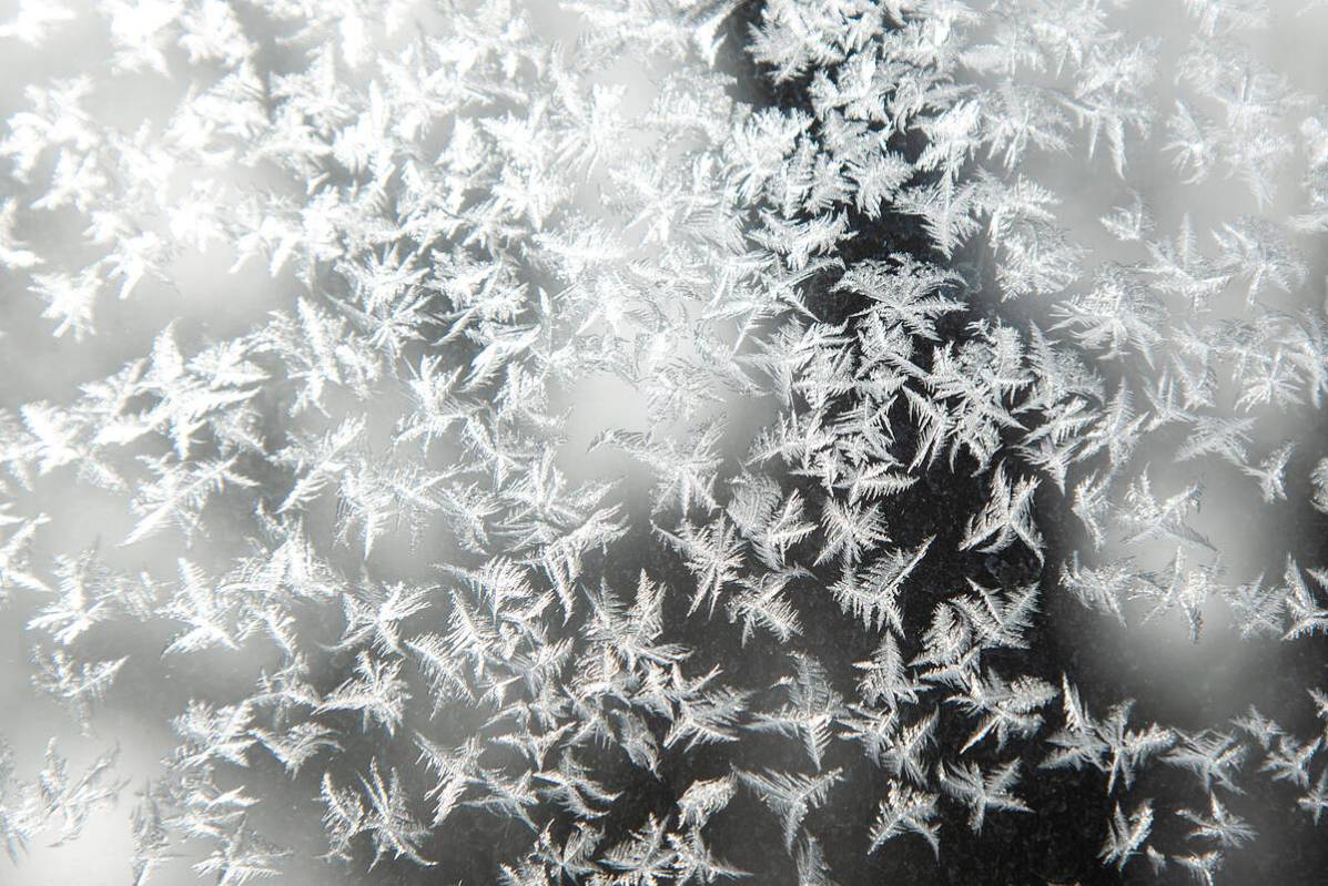 Frost forms on a storm window as temperatures remain below zero Fahrenheit during a blizzard wa ...