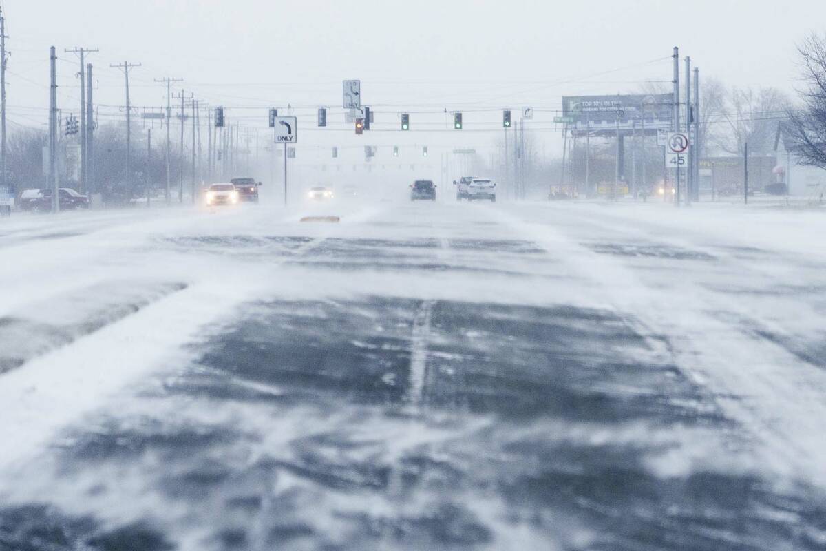 Wind blows snow Friday, Dec. 23, 2022, across U.S. 36 in Hendricks County, Ind. Winter weather ...