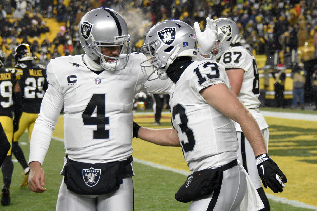 Las Vegas Raiders wide receiver Hunter Renfrow (13) celebrates with quarterback Derek Carr (4) ...