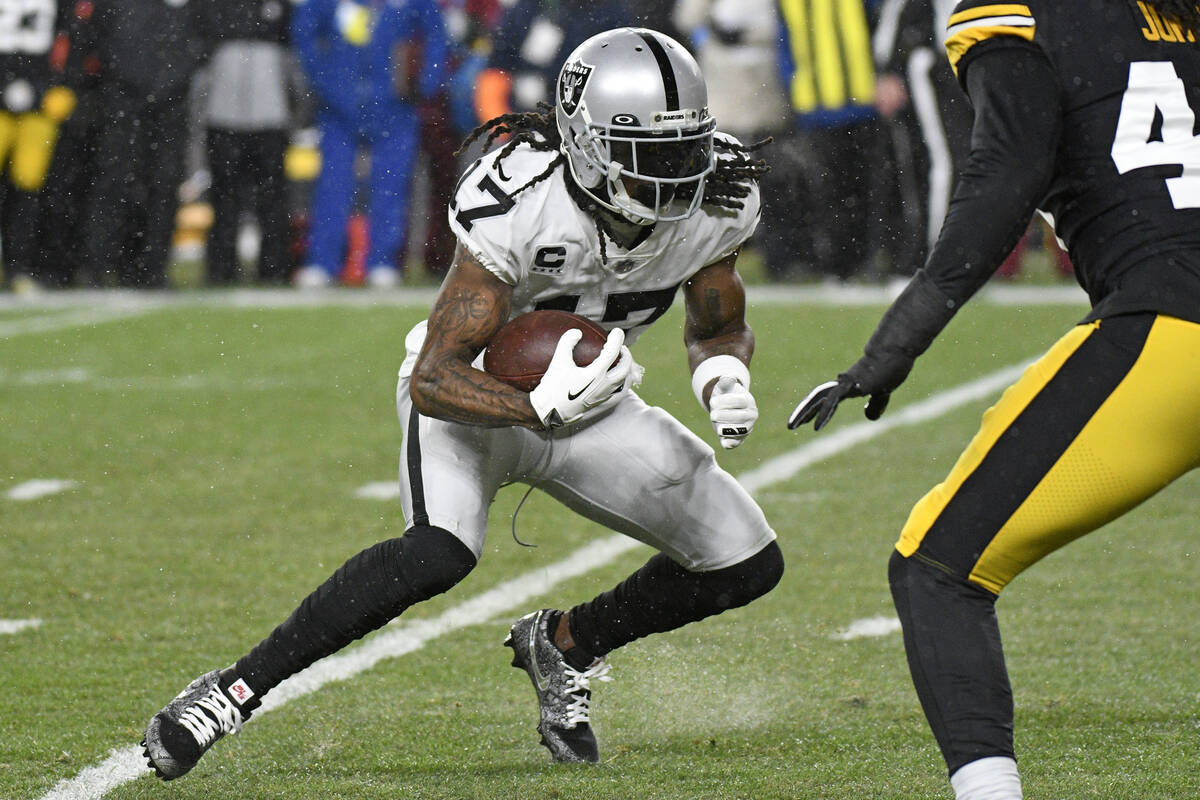 Las Vegas Raiders wide receiver Davante Adams (17) runs after a catch during the first half of ...