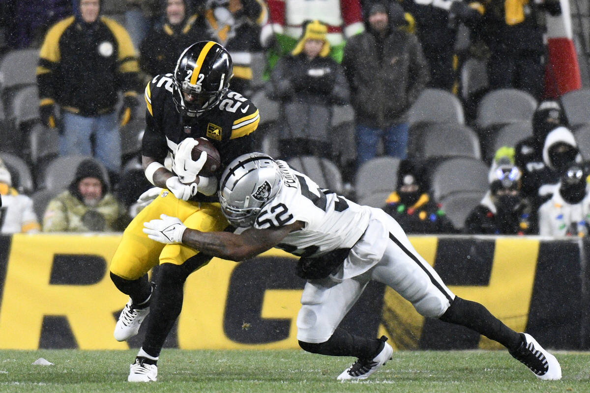 Pittsburgh Steelers running back Najee Harris (22) is tackled by Las Vegas Raiders linebacker D ...