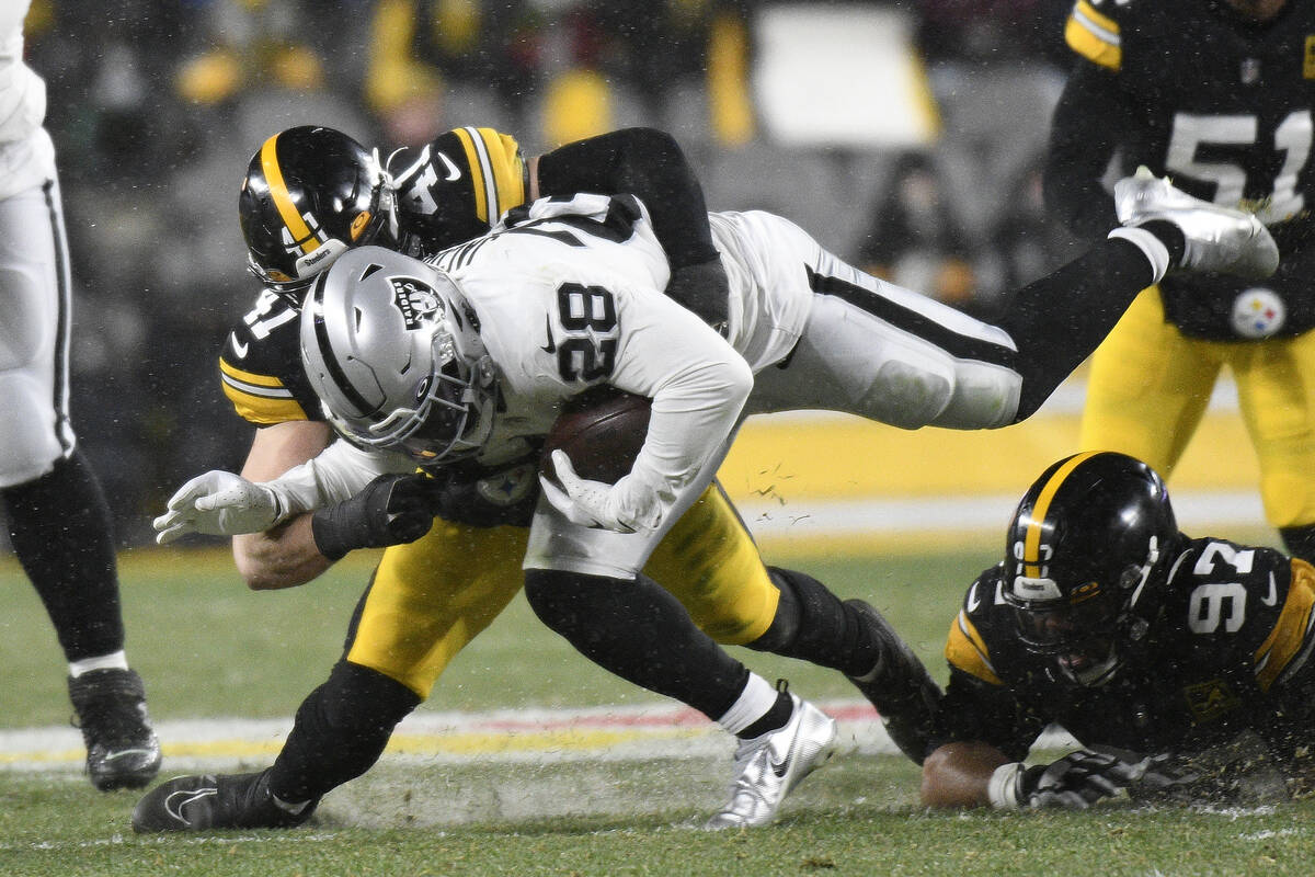 Las Vegas Raiders running back Josh Jacobs (28) is tackled by Pittsburgh Steelers linebacker Ro ...