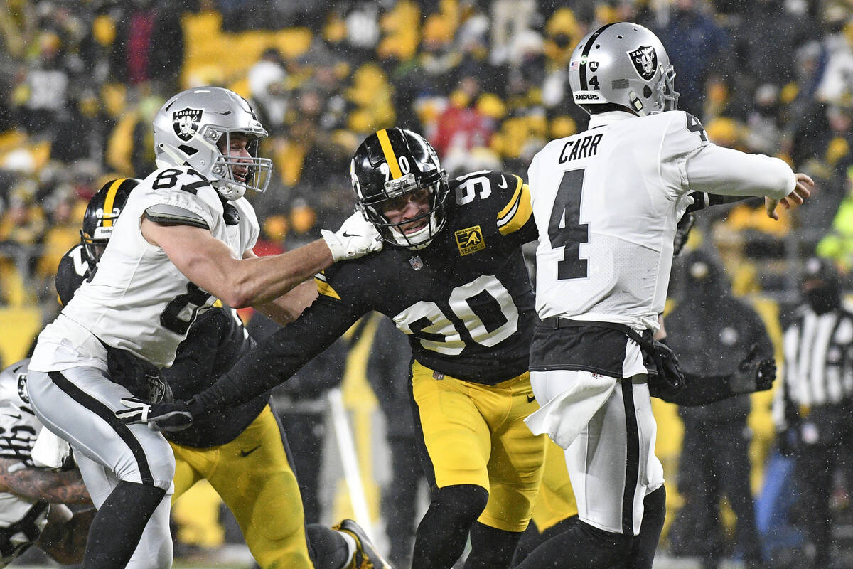 Pittsburgh Steelers linebacker T.J. Watt (90) can't get past Las Vegas Raiders tight end Foster ...