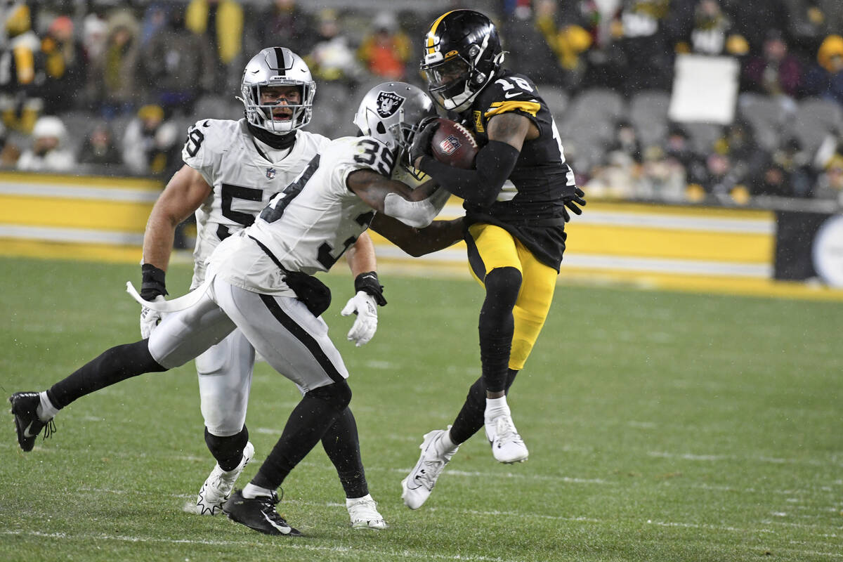 Pittsburgh Steelers wide receiver Diontae Johnson (18) is tackled by Las Vegas Raiders running ...