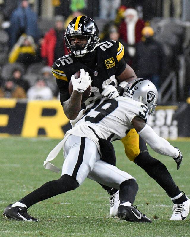 Pittsburgh Steelers running back Najee Harris (22) is tackled by Las Vegas Raiders cornerback N ...