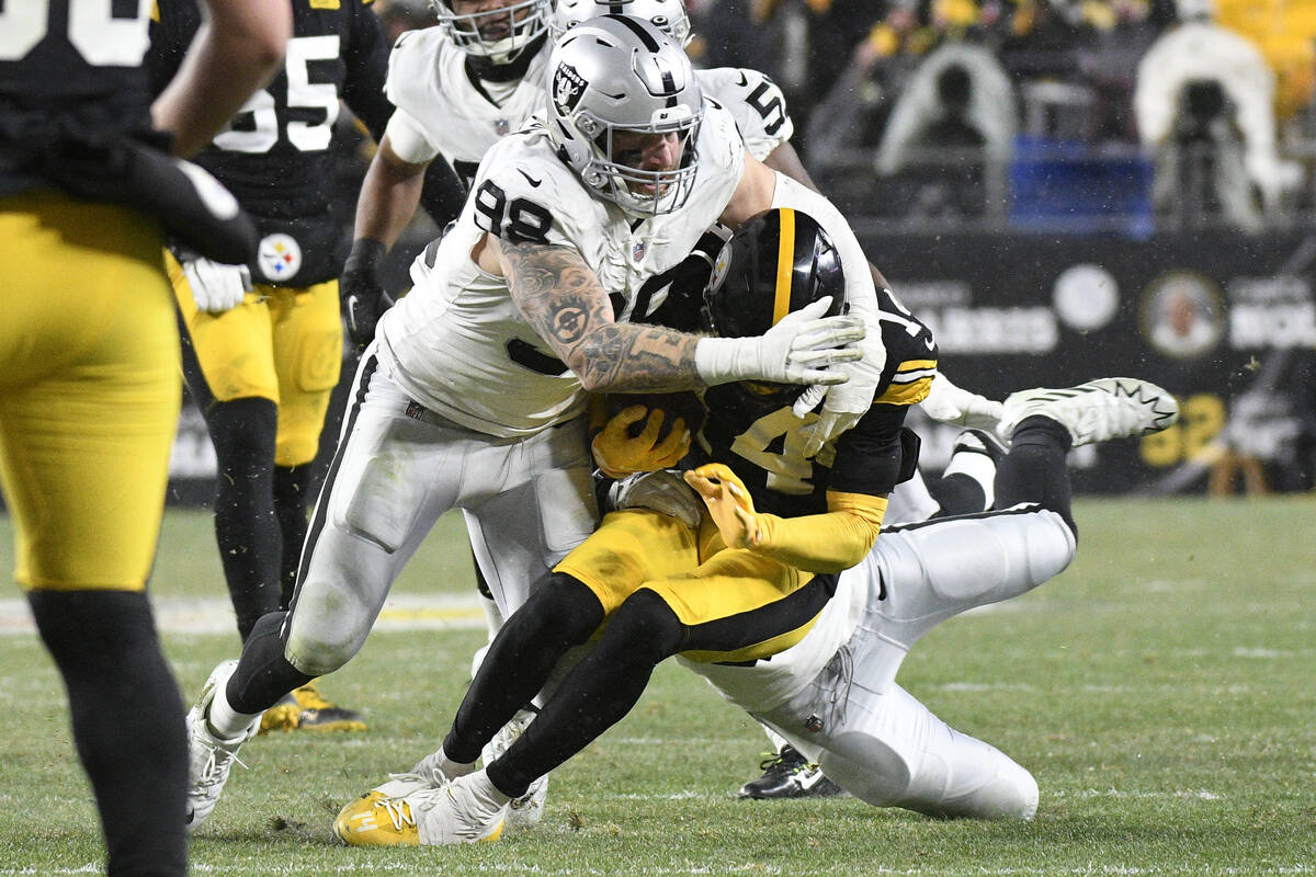 Pittsburgh Steelers wide receiver George Pickens (14) is tackled by Las Vegas Raiders defensive ...