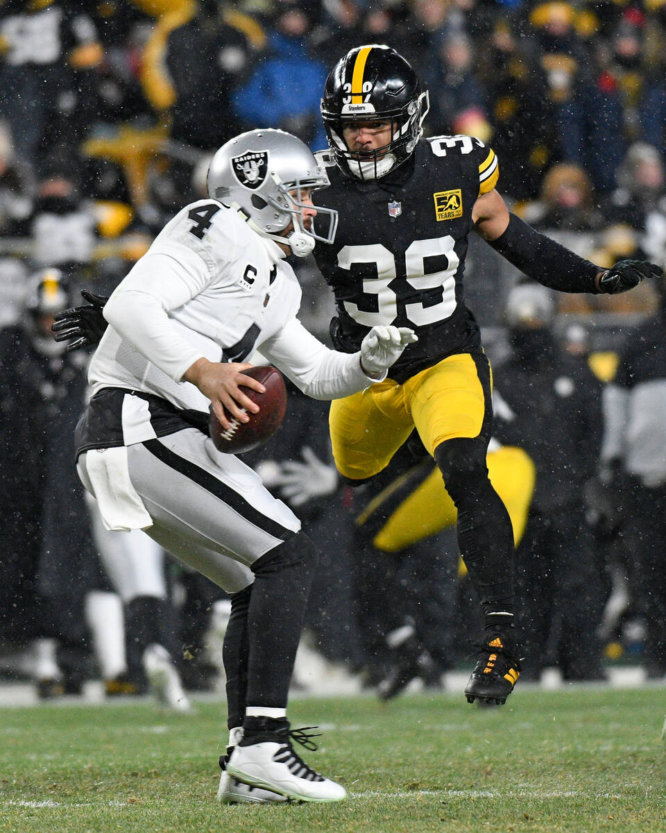 Las Vegas Raiders quarterback Derek Carr (4) is pressured by Pittsburgh Steelers safety Minkah ...