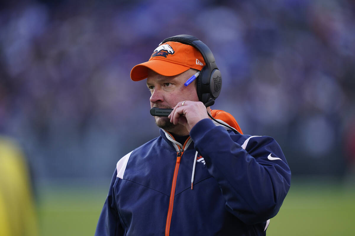 Denver Broncos head coach Nathaniel Hackett directs his team from the sideline, in the second h ...