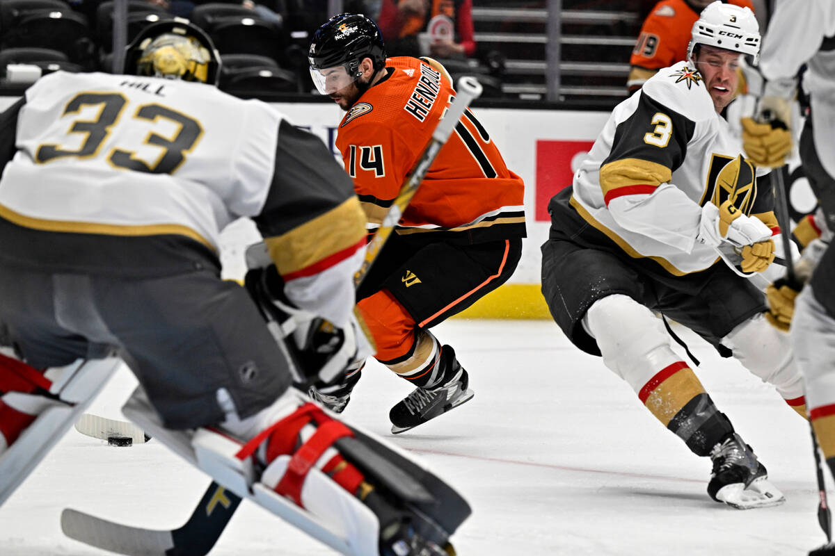 Anaheim Ducks center Adam Henrique, center, prepares to shoot against Vegas Golden Knights goal ...