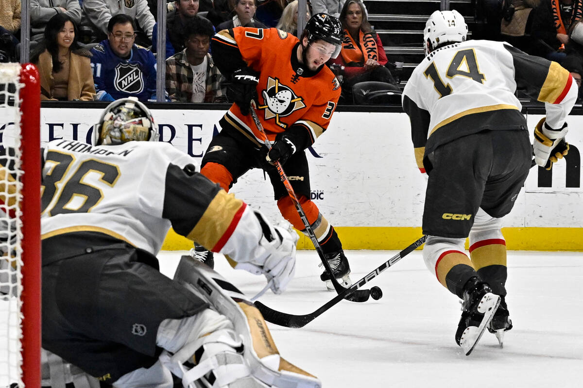 Anaheim Ducks center Mason McTavish, center, shoots the puck against Vegas Golden Knights goalt ...