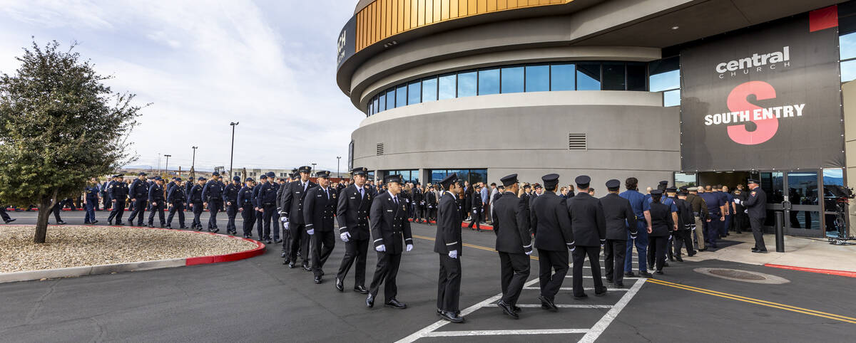 Mourners including coworkers and friends walk in the processional as Henderson Fire Department ...