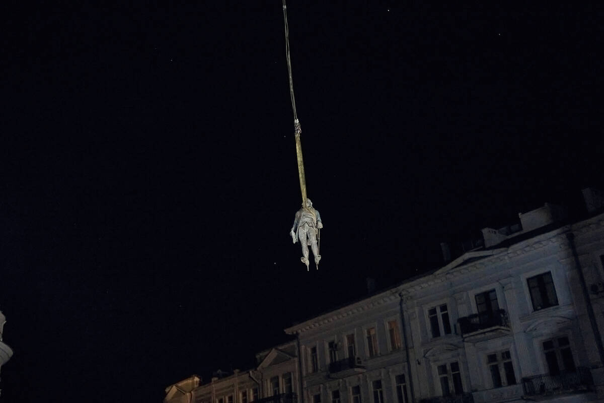 Workers remove part of the monument to Catherine II, also known as "Monument to the Founde ...