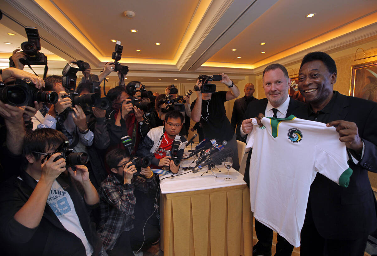 Brazilian soccer great Pele poses with Paul Kemsley, second right, chairman of the New York Cos ...