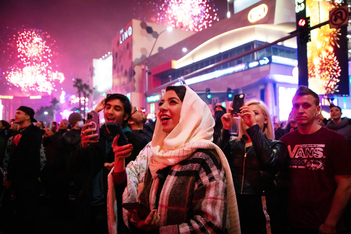 New Year’s revelers watch the fireworks on the Strip on Sunday, Jan. 1, 2023, in Las Vegas. ( ...