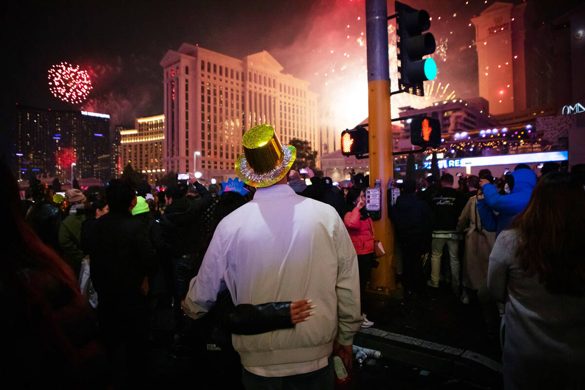 New Year’s revelers watch the fireworks on the Strip on Sunday, Jan. 1, 2023, in Las Vegas. ( ...