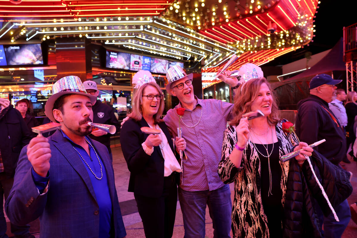 Revelers, from left, Rez Zia, Eric Bialo, Deb Bialo and Rachelle Zia, celebrate on New Year’s ...