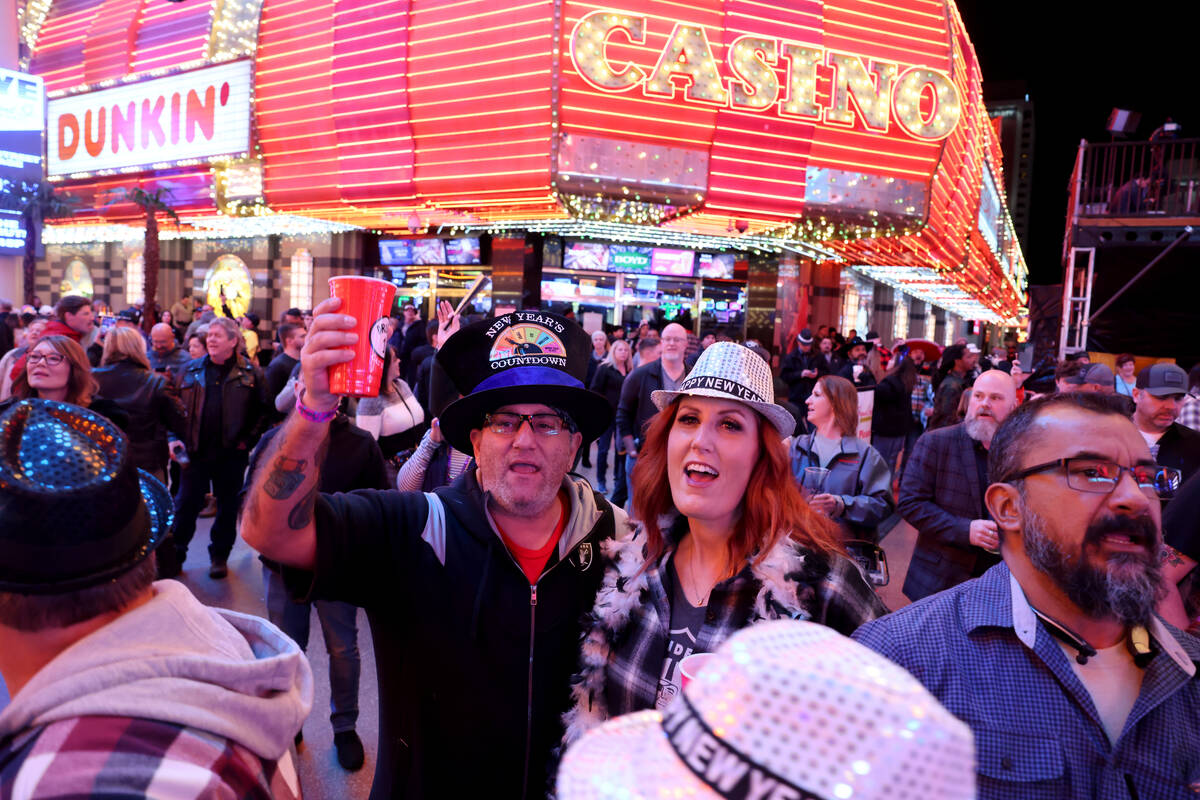 Daniel and Kate Freitas of Fresno, Calif., celebrate on New Year’s Eve at the Fremont Street ...