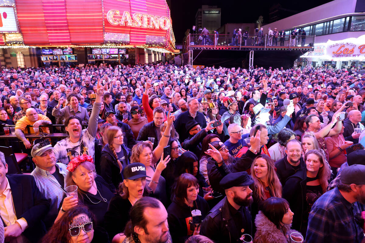 New Year’s Eve revelers rock out to Bush performing on the Third Street Stage at the Fremont ...