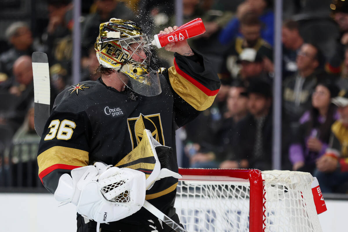 Vegas Golden Knights goaltender Logan Thompson (36) splashes water on his face during a break i ...