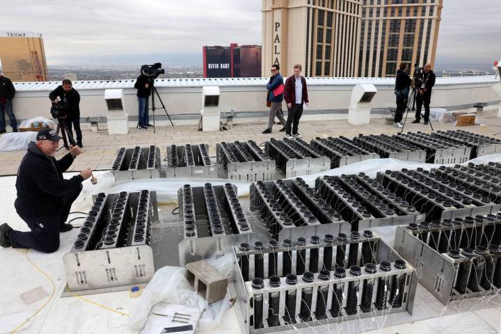 Fireworks by Grucci pyro technician Michael Wassmer loads pyrotechnics on the roof of The Venet ...