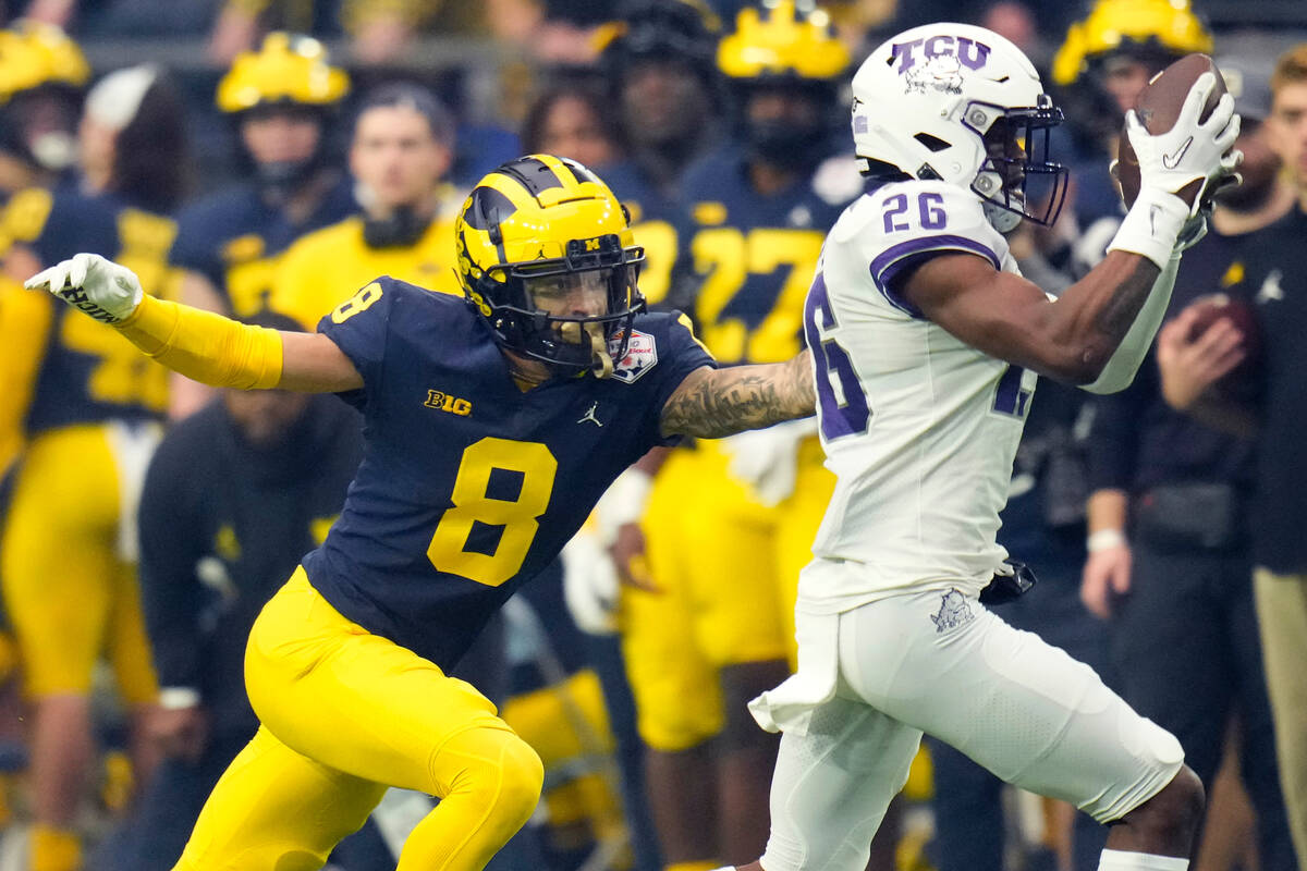TCU safety Bud Clark (26) celebrate his intercepts a pass intended for Michigan wide receiver R ...