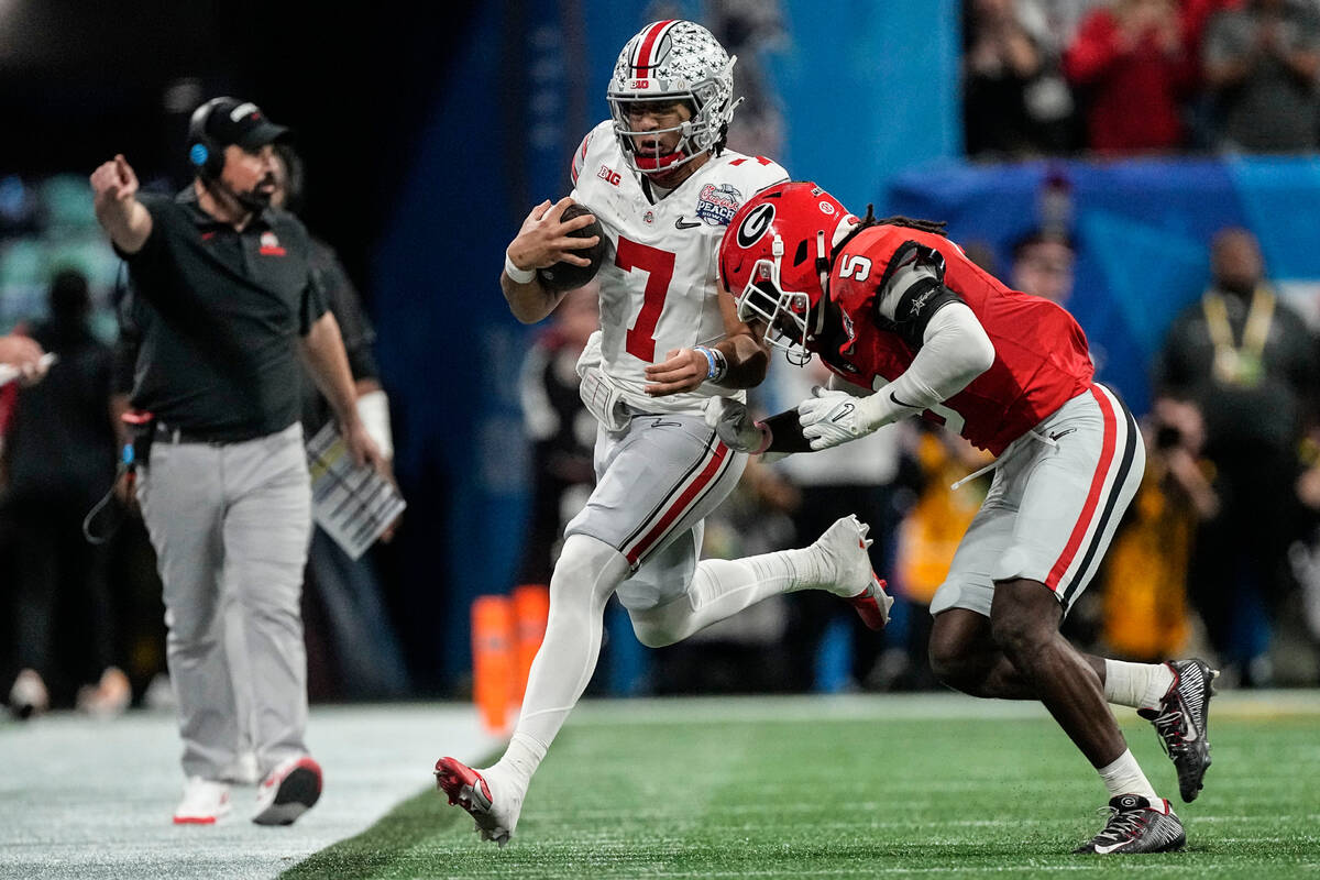 Georgia defensive back Kelee Ringo (5) hits Ohio State quarterback C.J. Stroud (7) during the f ...