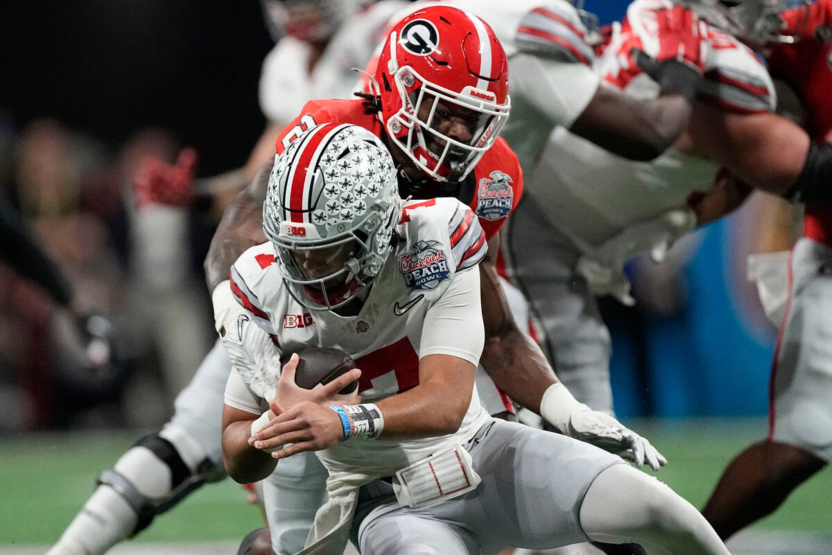 Georgia linebacker Smael Mondon Jr. (2) sacks Ohio State quarterback C.J. Stroud (7) during the ...