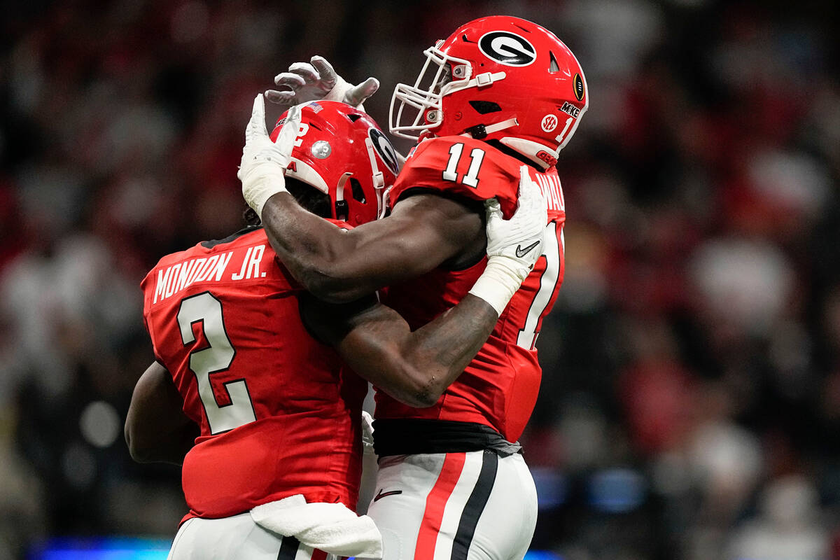 Georgia linebacker Smael Mondon Jr. (2) celebrates his sack with Georgia linebacker Jalon Walke ...