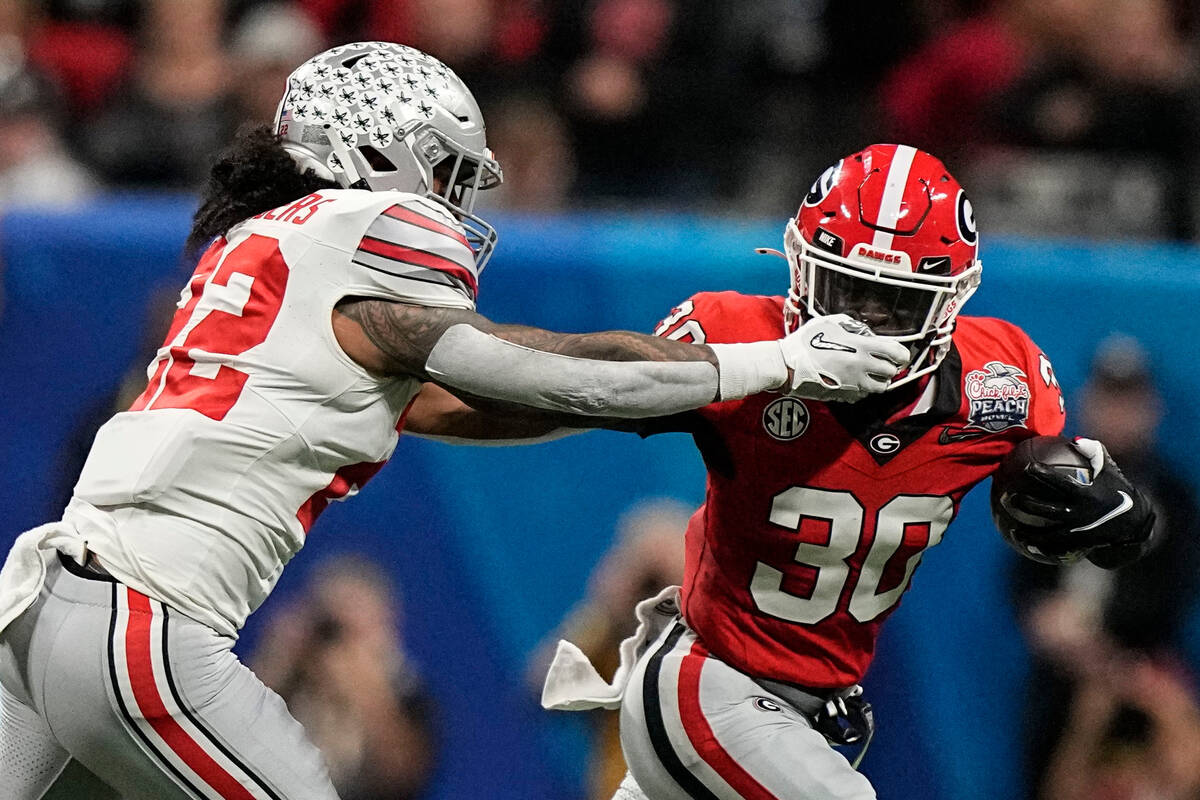 Ohio State linebacker Steele Chambers (22) hits Georgia running back Daijun Edwards (30) during ...