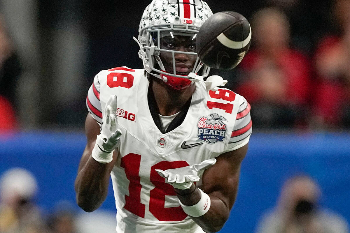 Ohio State wide receiver Marvin Harrison Jr. (18) makes a catch against Georgia during the firs ...
