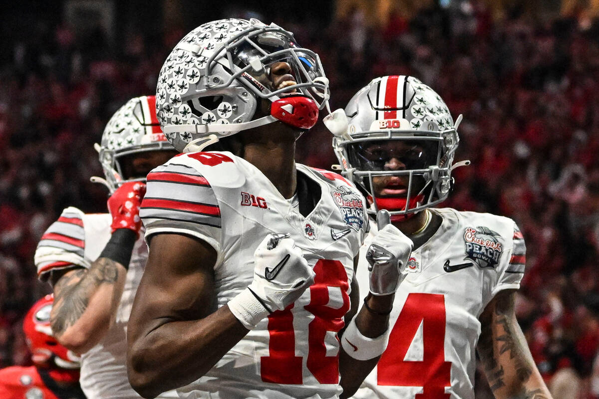 Ohio State wide receiver Marvin Harrison Jr. (18) celebrates his touchdown catch against Georgi ...