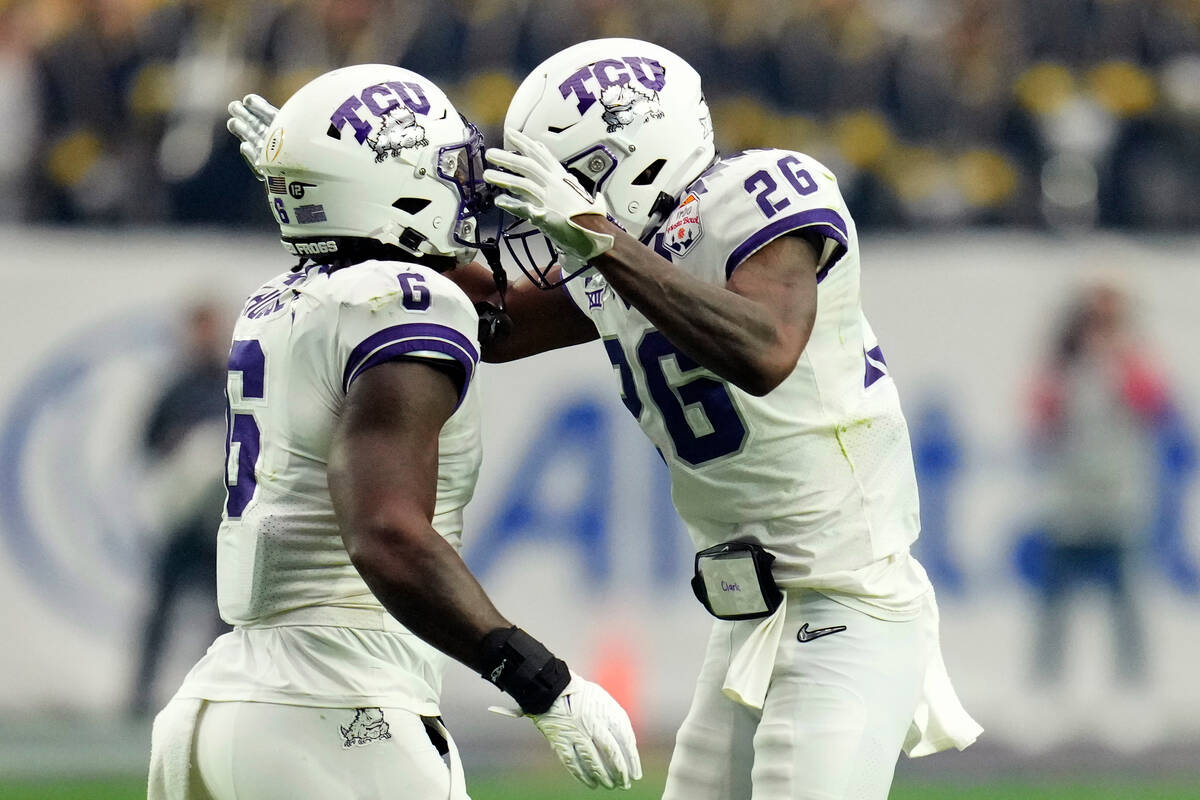 TCU safety Bud Clark (26) and linebacker Jamoi Hodge celebrates a goal line stop against Michig ...