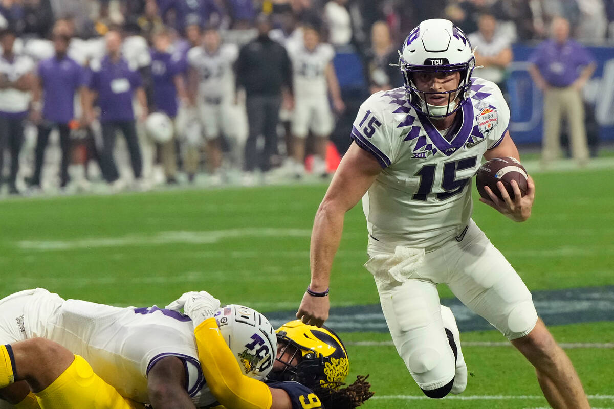 TCU quarterback Max Duggan (15) runs the ball against Michigan during the first half of the Fie ...