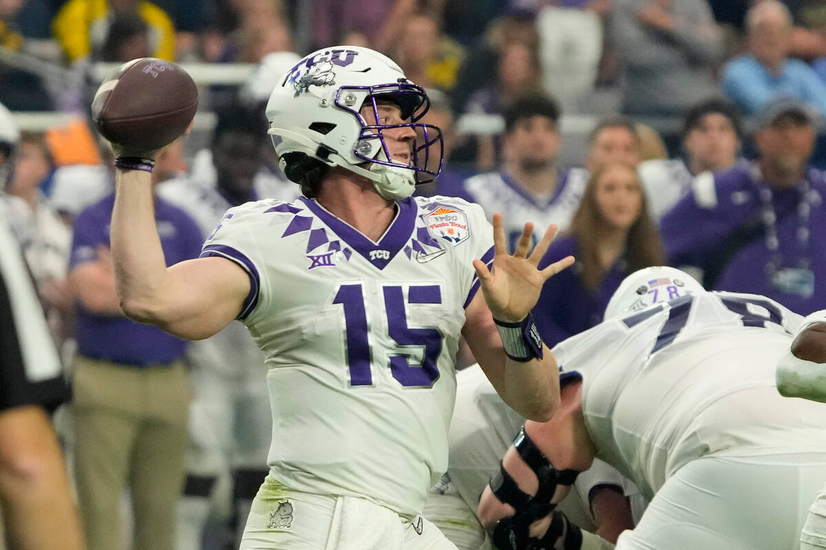 TCU quarterback Max Duggan (15) throws against Michigan during the first half of the Fiesta Bow ...