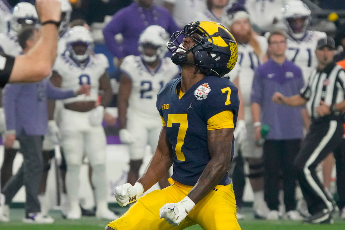 Michigan defensive back Makari Paige celebrate his sack on TCU quarterback Max Duggan during th ...