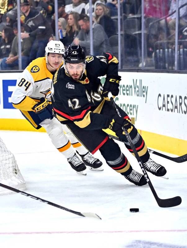 Vegas Golden Knights defenseman Daniil Miromanov (42) skate with the puck ahead of Nashville Pr ...