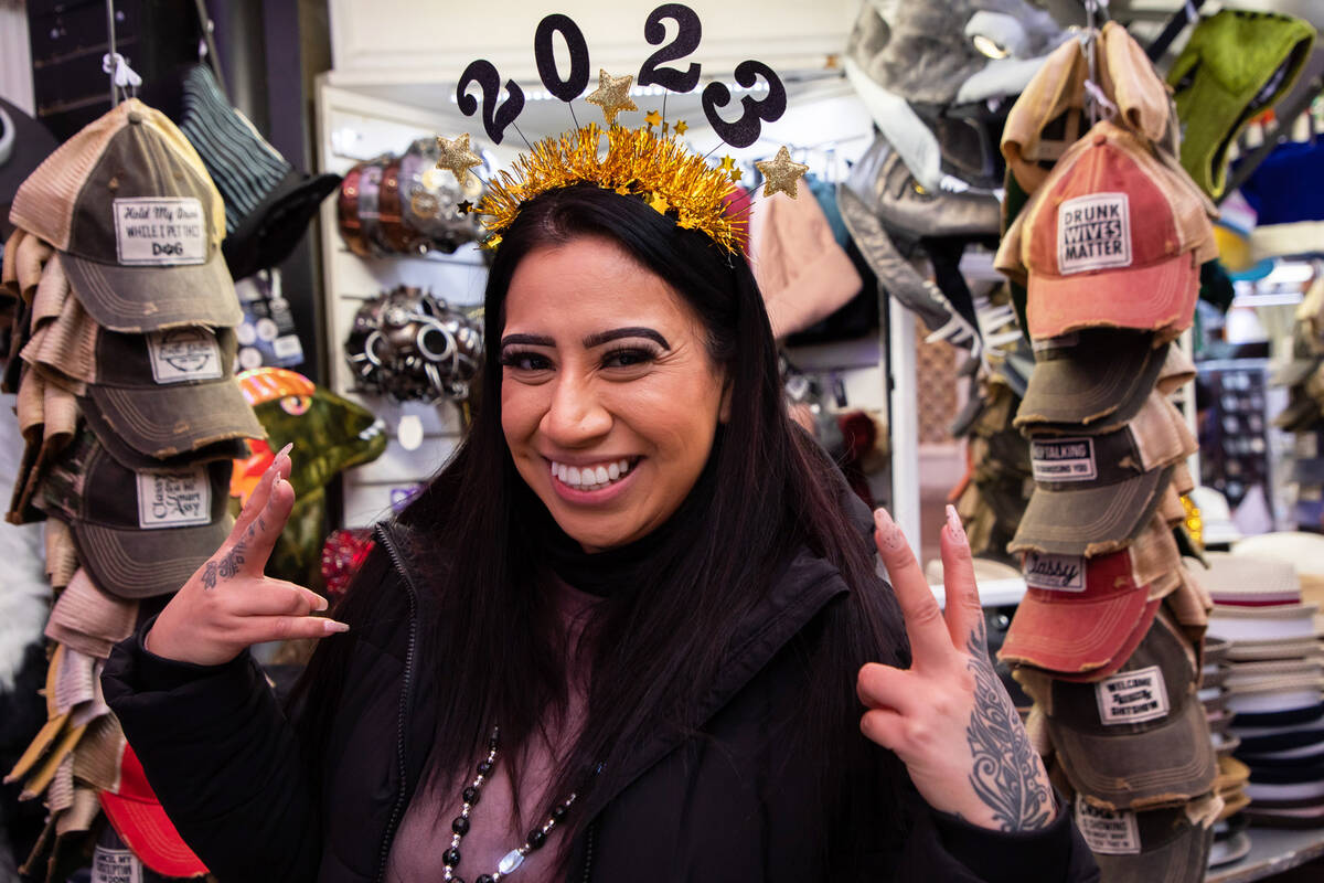 Wendy Boyas, of California, poses for a photo with her New Year’s Eve headband on Saturday, D ...