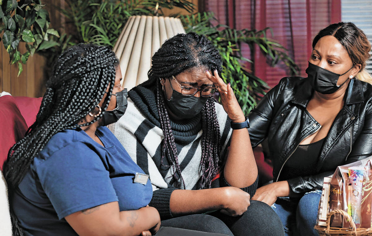 Jessica Stingley, from left, LaShonda Warfield and LaTory Houston react as they talk about Tana ...