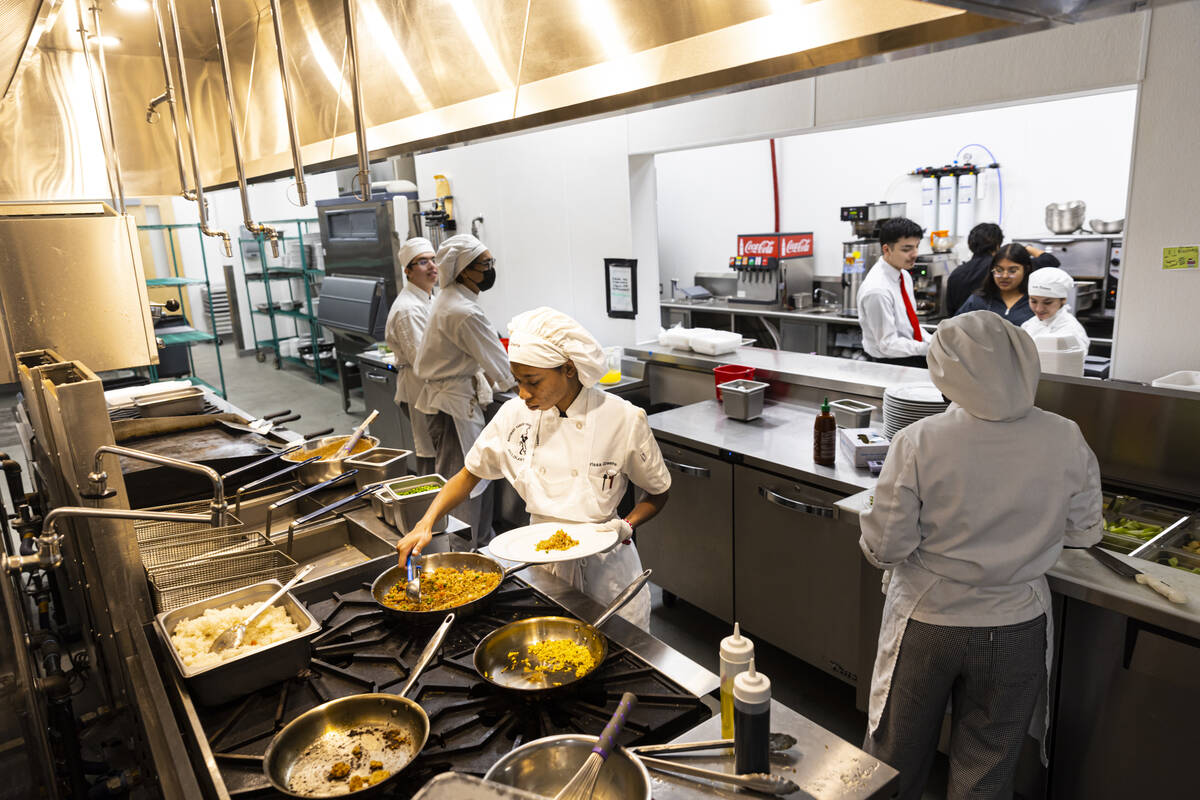 Southeast Career Technical Academy culinary student Arissa Greene prepares shrimp fried rice on ...