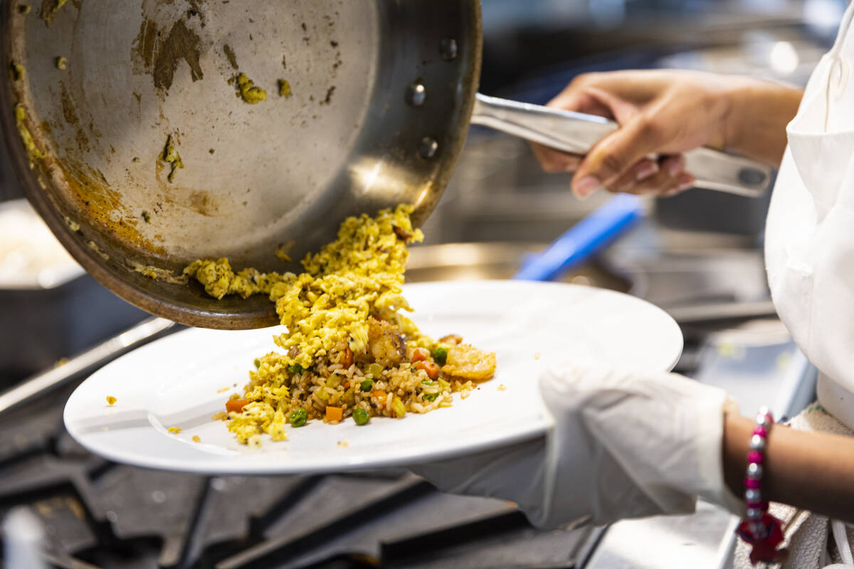 Southeast Career Technical Academy culinary student Arissa Greene prepares shrimp fried rice on ...