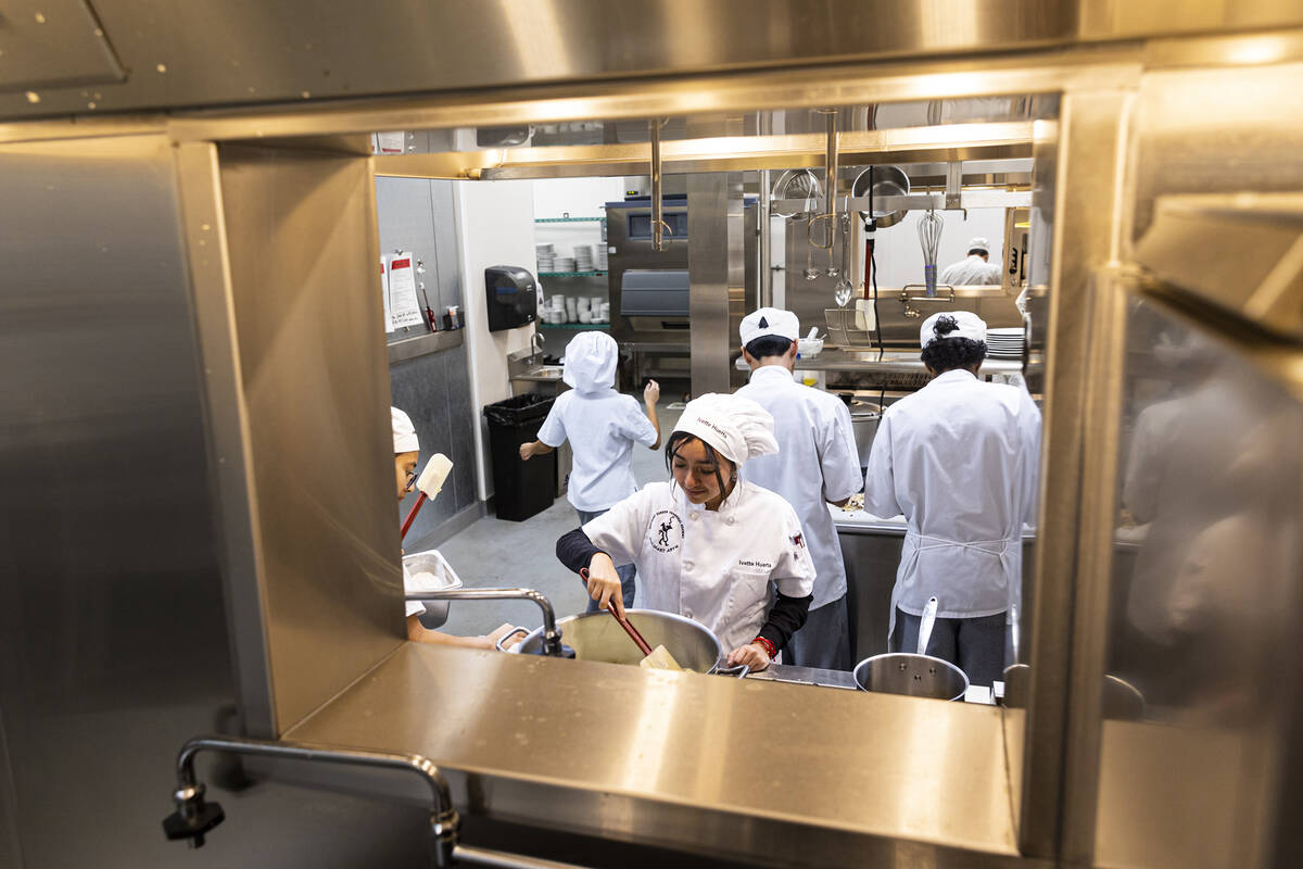 Southeast Career Technical Academy culinary students, including Ivette Huerta, center, work in ...