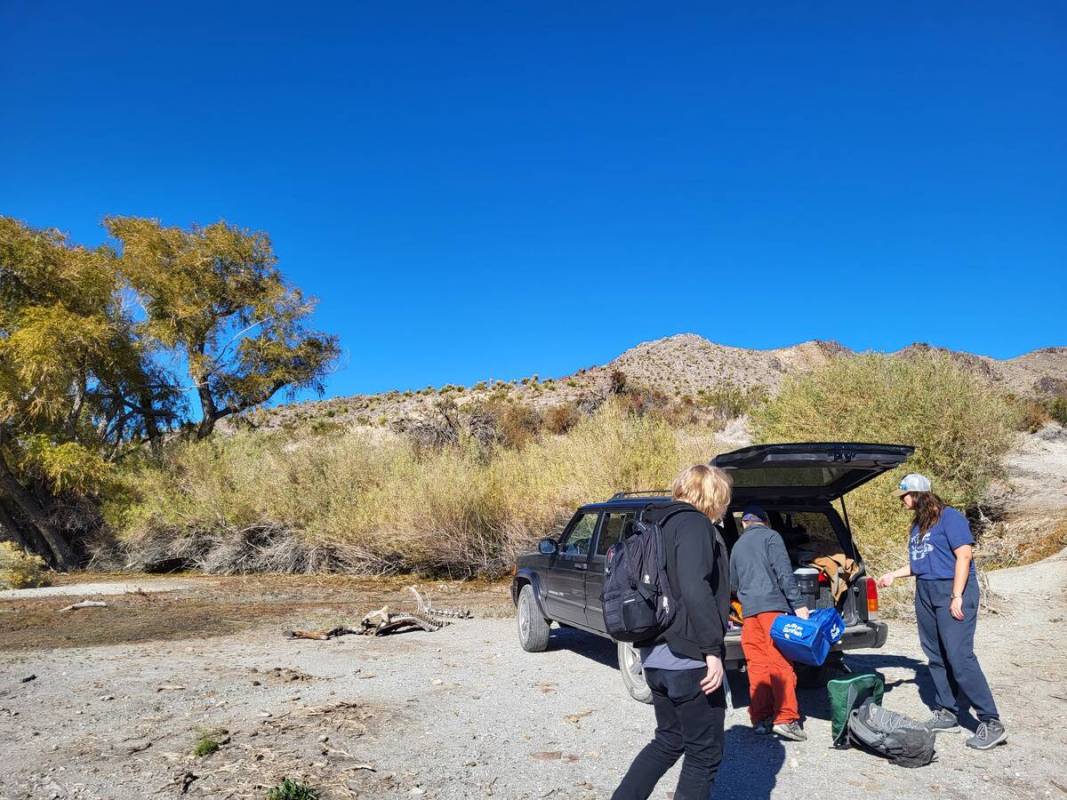 UNLV researchers Cale Seymour (left), Brian Hedlund (center) and Marike Palmer (right) unloadin ...