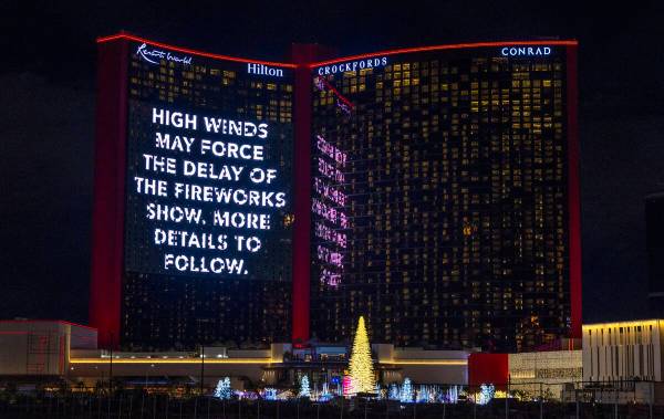 A high winds alert notice on the large video display at Resorts World on New Year’s Eve ...