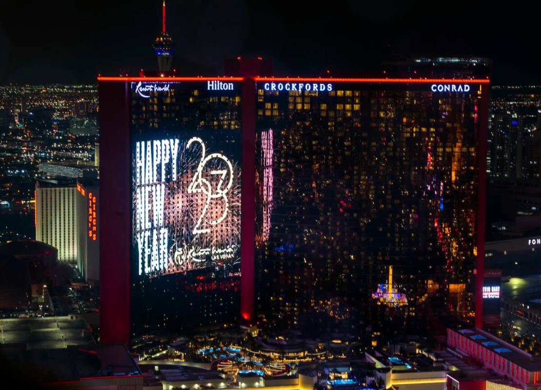 New Year’s Eve wishes on the giant video screen of Resorts World viewed from atop the Tr ...