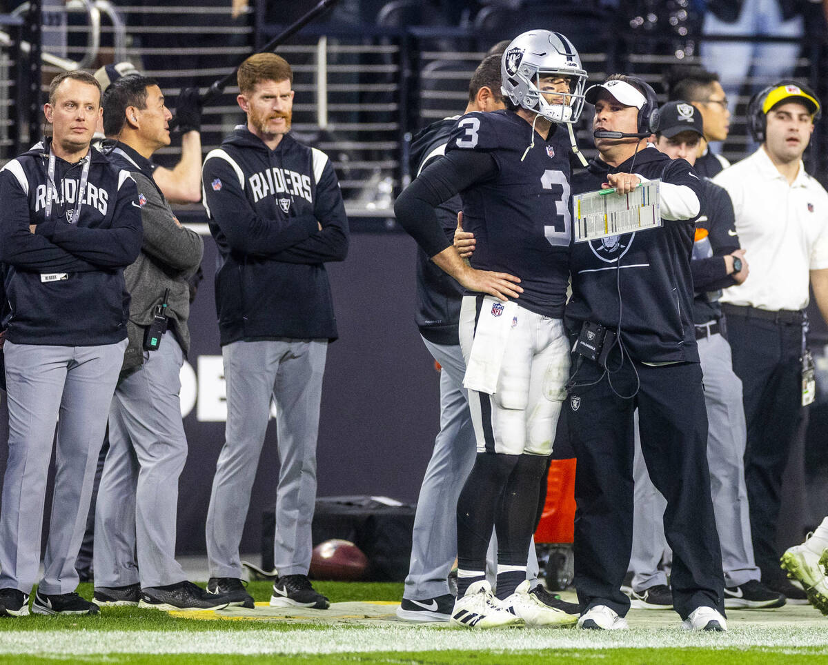 Raiders quarterback Jarrett Stidham (3) is counseled on the sidelines by Head Coach Josh McDani ...