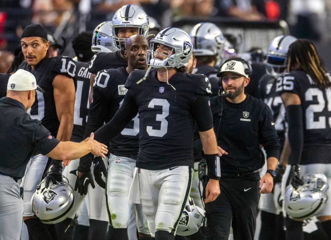 Raiders quarterback Jarrett Stidham (3) receives accolades from players and coaches following a ...